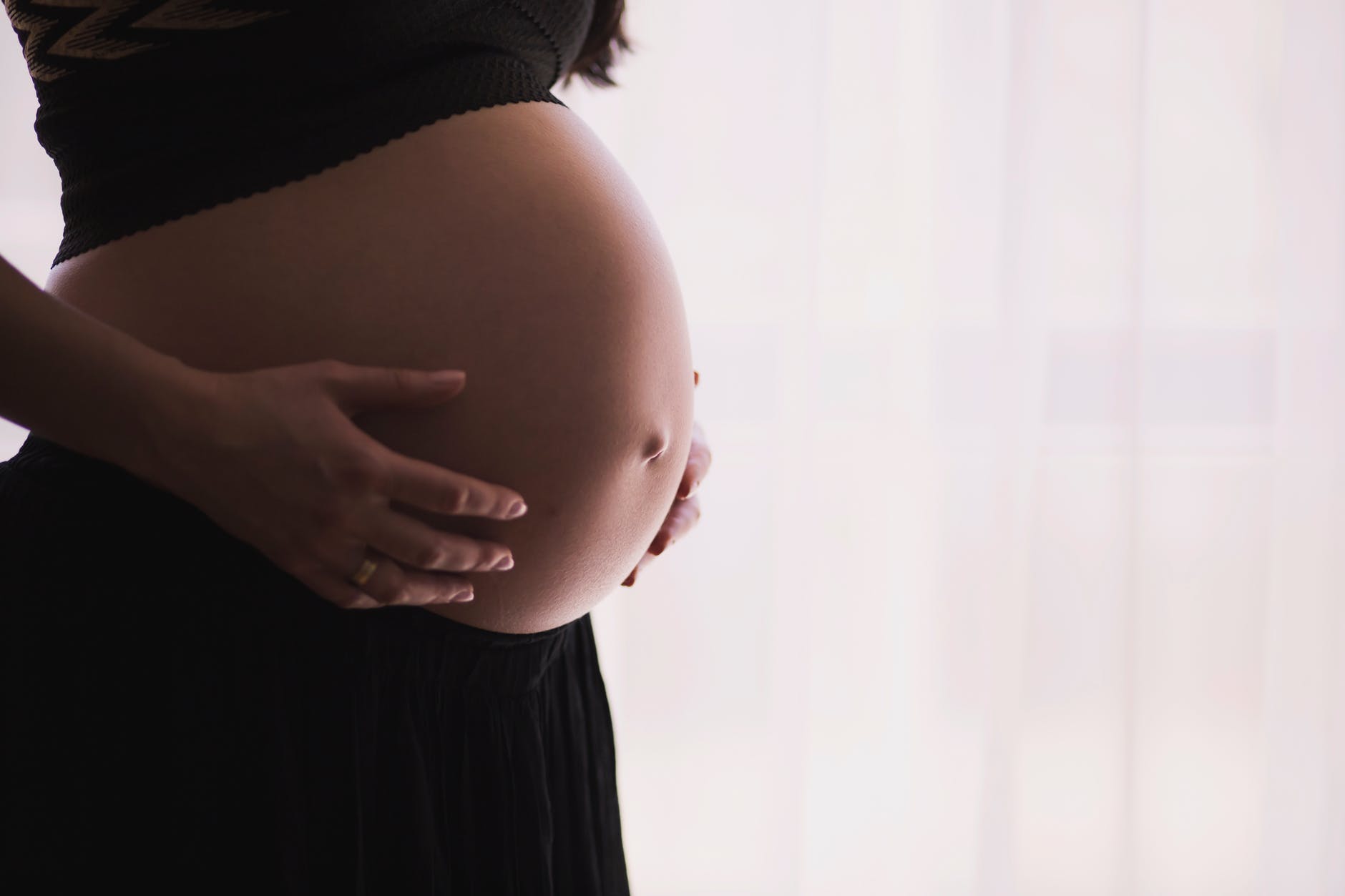 pregnant woman holding tummy